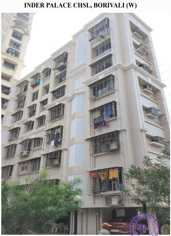 Multi-story residential building with barred windows and air conditioners, labeled Inder Palace CHSL in Borivali (W), surrounded by greenery.